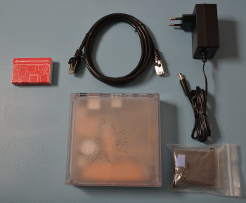 Image showing the Home Assistant Yellow with a Raspberry Pi Compute Module 5, Heat sink assembly bag, Ethernet cable, power supply, a USB flash drive, and an NVMe M.2 SSD drive